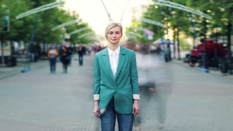 woman in teal jacket on city street