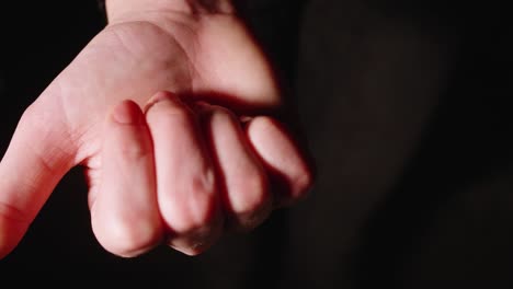 girl opens fist and shows two rings in palm