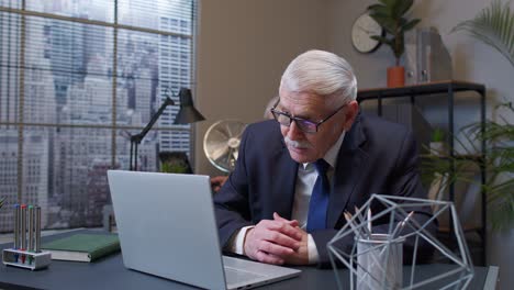 business man using laptop, internet online meeting conference in office webinar talking on webcam