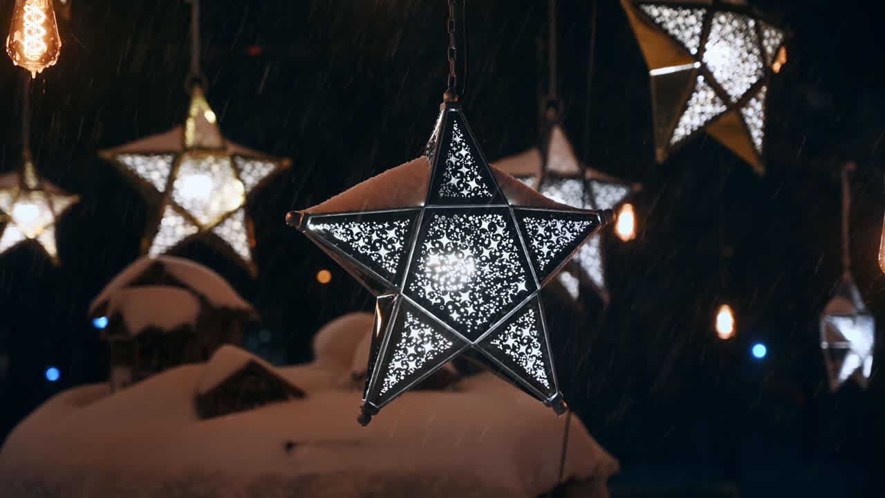 Close up view of the star-shaped lanterns in the park during snowfall. Christmas decorations. Winter evening