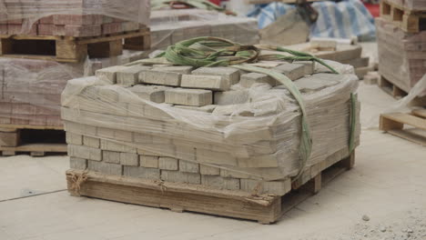 static shot of interlocking concrete block on wood pallet at construction depot