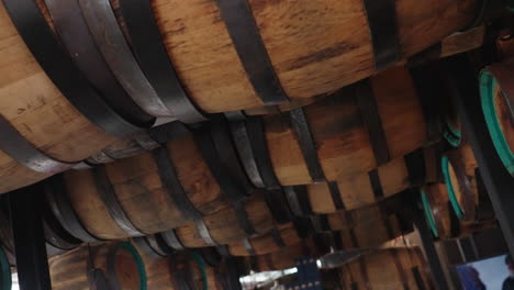 vintage wine barrels stored on overhead cellar roof, close up 4k slow motion