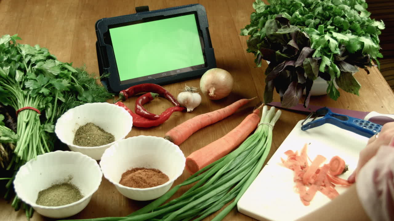 Preparing fresh ingredients for cooking with the help of a tablet