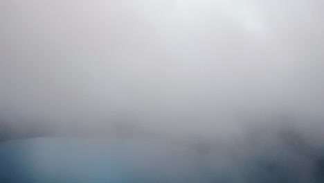 aerial revealing shot over clouds of the tziscao lake, montebello national park, chiapas