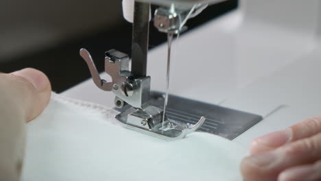 sewing machine working close up view in slow motion. clothing industry concept.