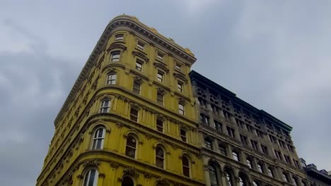 1870s-old-hotel-worms-eye-view-next-to-mid-1800s-office-tower-with-crescent-window-frame-stonework-replica-found-in-common-buildings-in-Europe