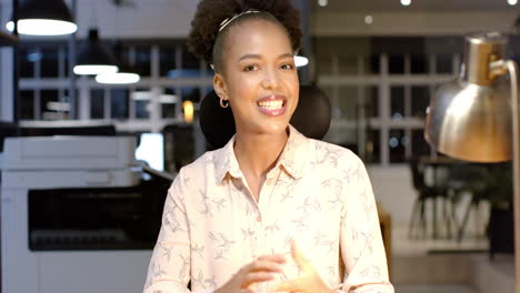 young african american woman smiles brightly in a business office setting