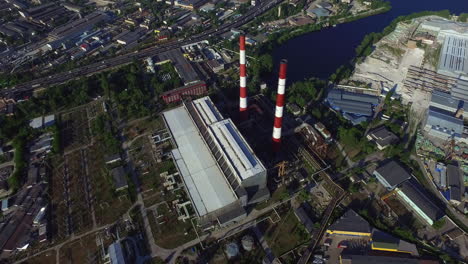 Drone-view-industrial-chimney-on-power-plant-on-urban-landscape