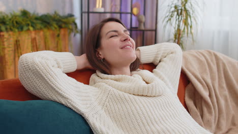 tired lazy woman enjoy relaxing on home sofa resting napping after hard working day, closed her eyes