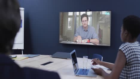 diverse business people on video call with caucasian male colleague on screen