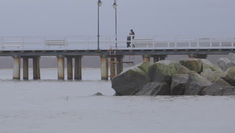 People-At-The-Bridge-Over-The-Beach-In-Redlowo,-Gdynia-Poland