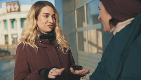 female friends talking and laughing in the city