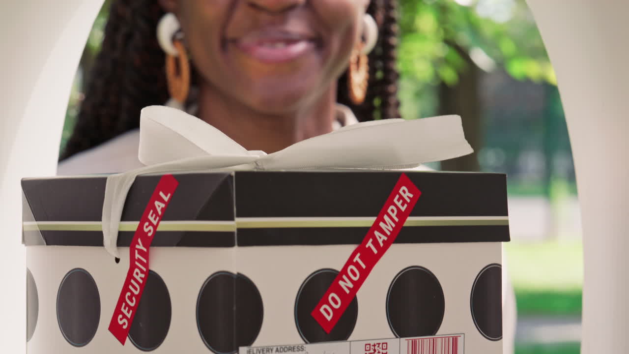 Joyful African American Woman Picking Up Gift Box Parcel from Mailbox