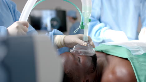 diverse female surgeons operating on african american patient in operating theatre, slow motion