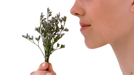 blonde woman smelling dried lavander