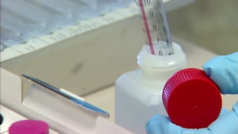 lab syringe filling up liquid