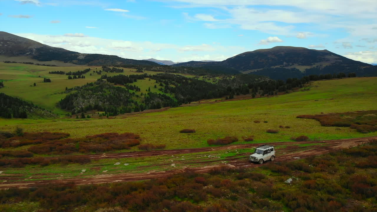 SUV driving through a scenic mountain landscape
