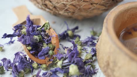 dried flowers in wooden bowl and spoon