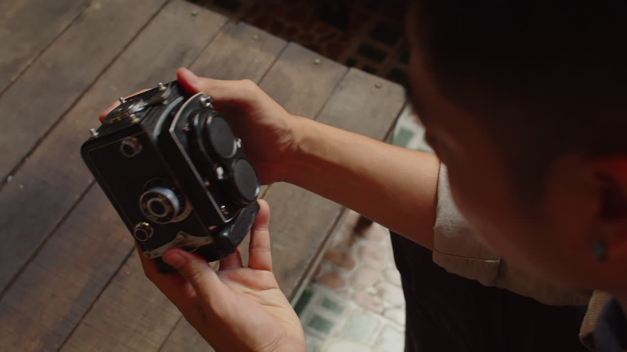 Man Checking Old Camera
