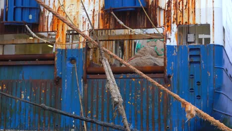 rusty ship and used ropes in a port