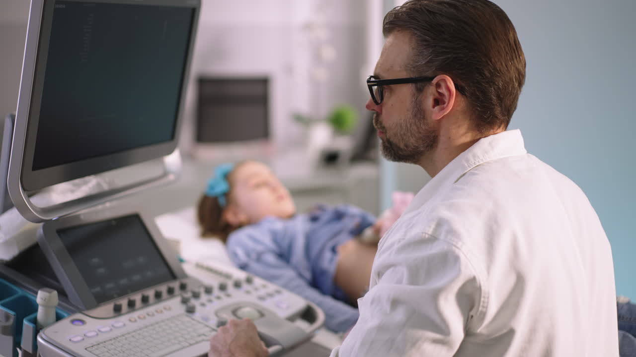 Doctor performing an ultrasound on a young patient