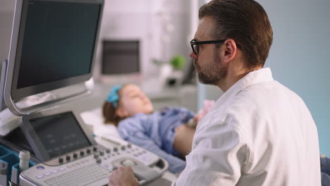 doctor performing an ultrasound on a young patient