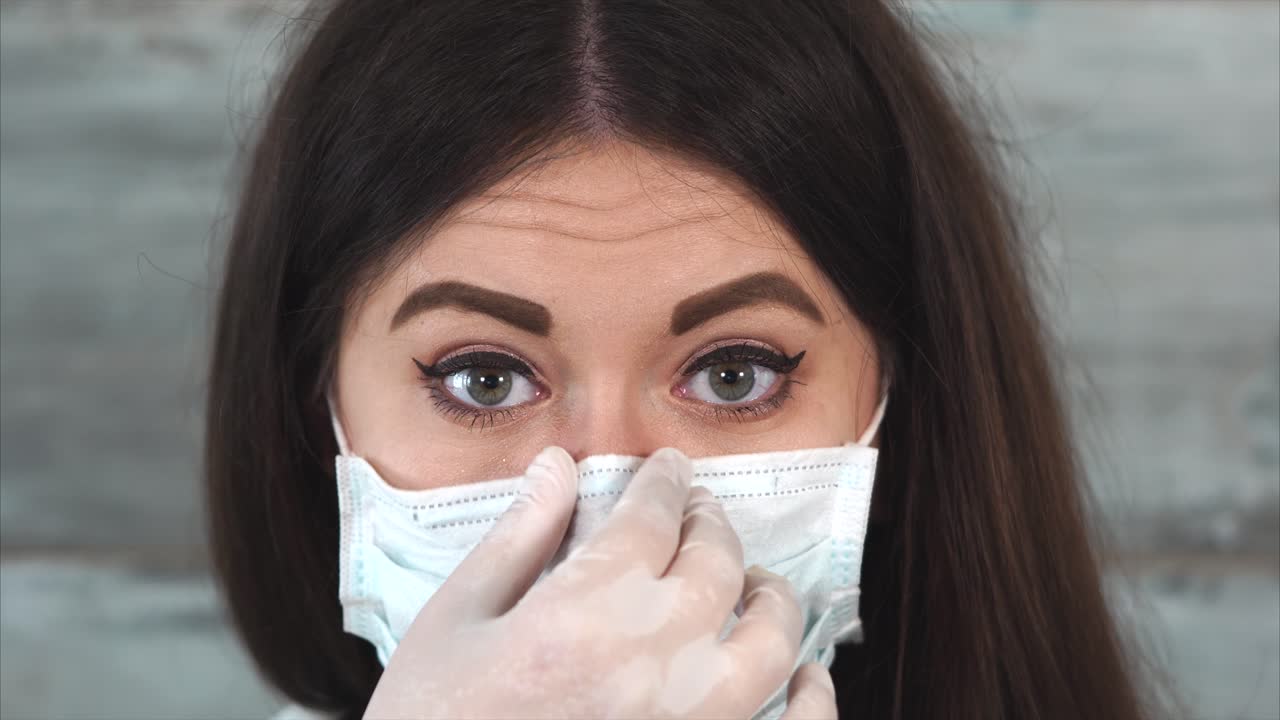 Woman Wearing a Medical Mask and Gloves