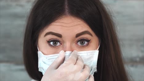 woman wearing a medical mask and gloves