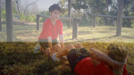 two kids in red shirts exercising outdoors with autumn leaves animation overlay