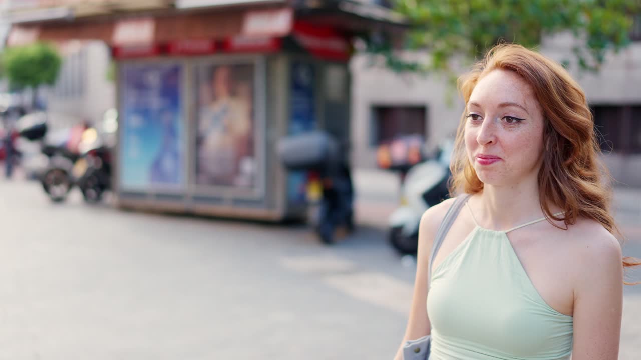 Two joyful women embracing in a heartfelt hug on a city street