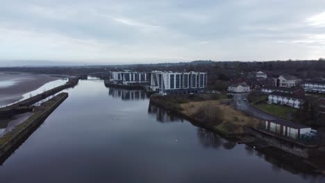 early morning aerial view riverside waterfront contemporary apartment push in towards office buildings canal regeneration real estate