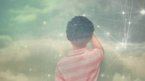 animation of a boy with clouds floating over a web of connected dots in the background