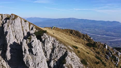 departure of colorful paraglider from mount pizzocco, adventure sport aerial