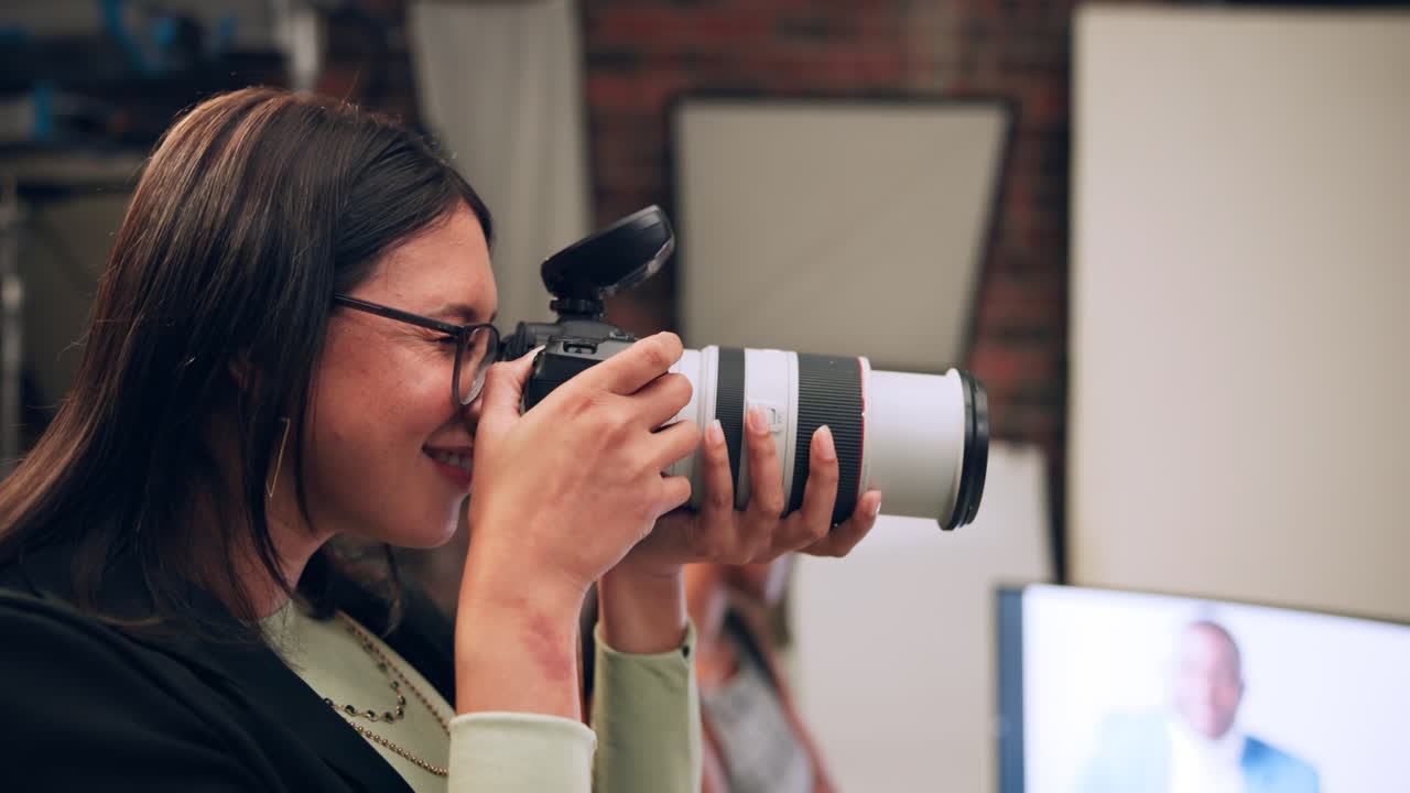 A woman is taking photos in a studio