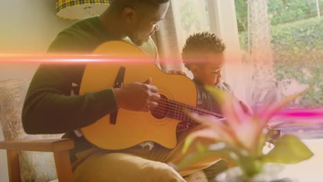 animation of light flashing over african american father and son playing guitar