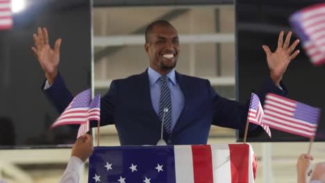 Victorious-male-speaker-and-audience-at-political-convention