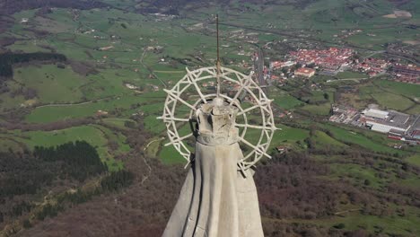 Aerial-drone-view-of-a-large-monument-statue-of-the-Virgin-of-Orduña-on-the-top-of-Mount-Txarlazo-in-the-Basque-Country