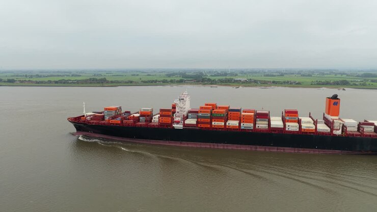 Drone shot of freight ship navigating waterway for import export work