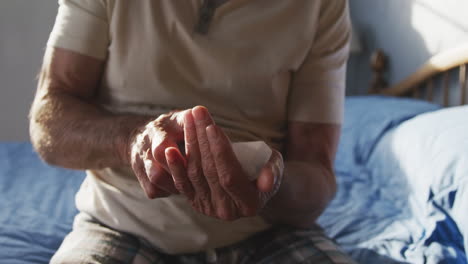 senior man with medical drugs at home