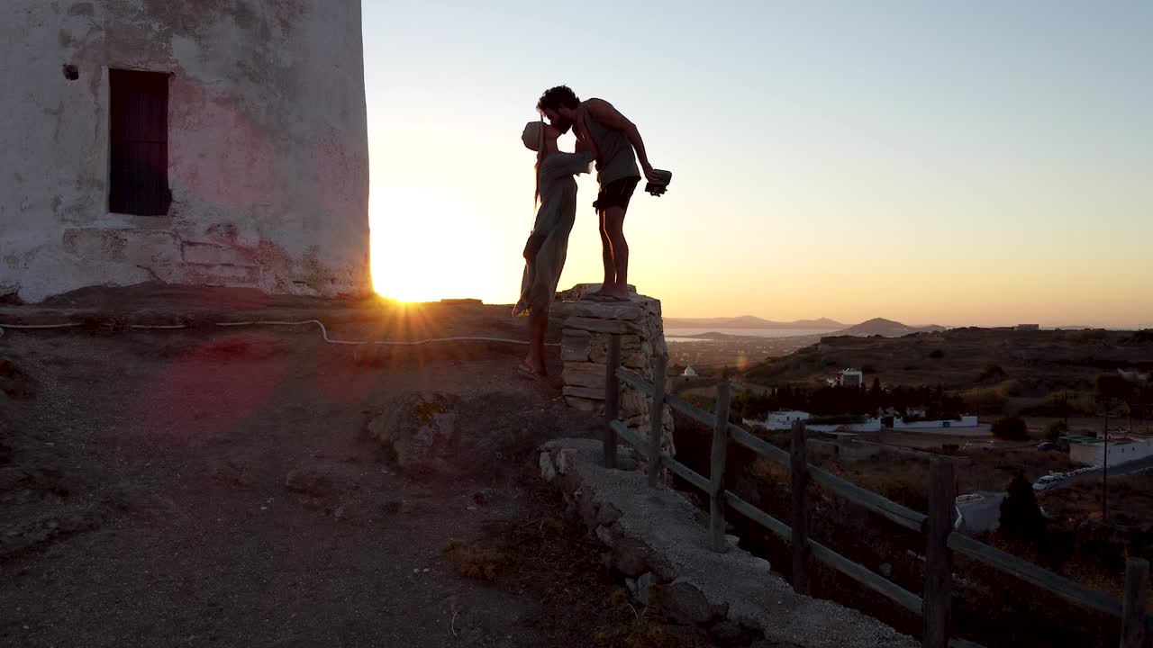 Romantic Couple Enjoying Naxos Sunset in Vivlos Village Windmills, Greece
