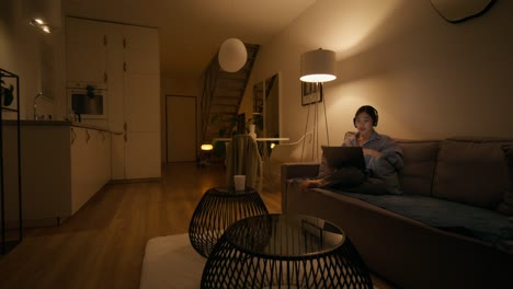 woman working on laptop at home at night