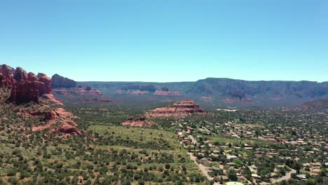 aerial panoramic of suburbs and red-rock buttes in the town of sedona, arizona