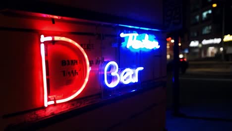 bright neon sign flickering outside a bar creates a vibrant atmosphere in the bustling nightlife of the city