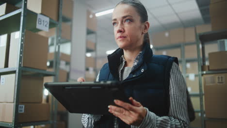 warehouse worker using tablet for inventory management