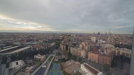 mountain range and milan cityscape, view from rising elevator