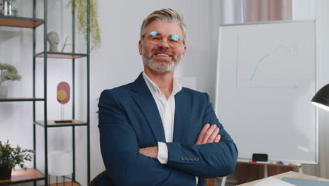 mature business man sitting at office workplace desk closing laptop pc after finishing remote work