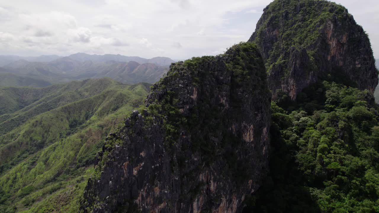 Cliff mountain with lush forest creates sense of adventure and tranquility