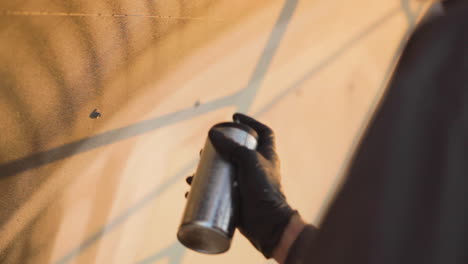 Graffiti artist spray painting a wall