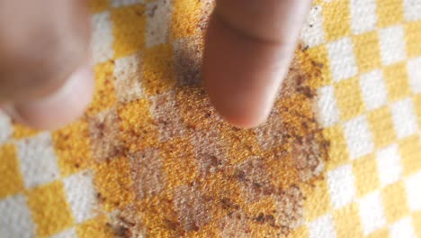 finger on a stained tablecloth