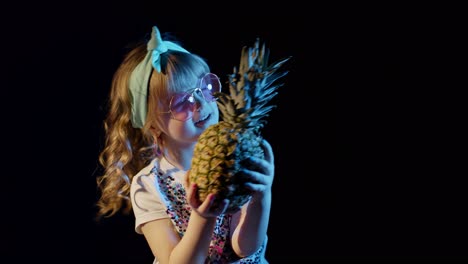 Trendy-stylish-girl-in-sunglasses-with-pineapple-singing,-fooling-around-at-disco-cyberpunk-club